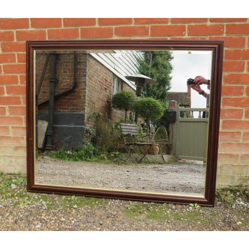 824 - A large rectangular bevelled wall mirror within a parcel gilt and moulded wooden surround. 
H104cm W... 