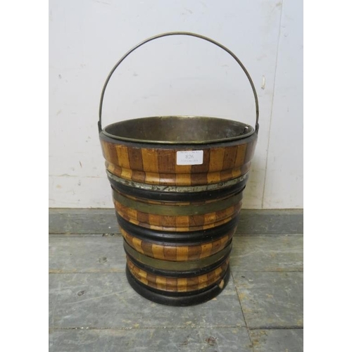 826 - A 19th century Dutch peat bucket, having sectioned walnut and maple sides with copper and ebonised b... 