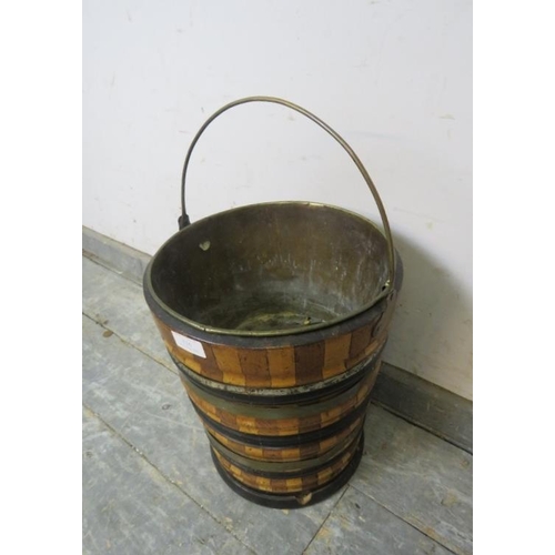 826 - A 19th century Dutch peat bucket, having sectioned walnut and maple sides with copper and ebonised b... 