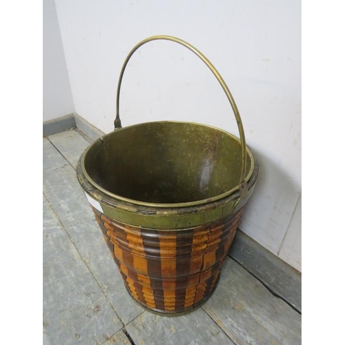 827 - A 19th century Dutch peat bucket, having sectioned mahogany, walnut and maple sides with brass bandi... 