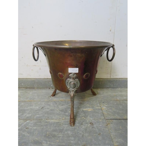 828 - A 19th century copper planter, with drop-ring handles and repousse roundel decoration, on hoof feet.... 