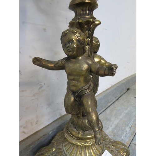 830 - A vintage gilt metal table lamp in the Rococo taste, having faceted glass and cherub decoration, on ... 