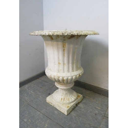 841 - An antique cast iron campana urn painted white, on a plinth base. 
H72cm W58cm (approx).
Condition r... 