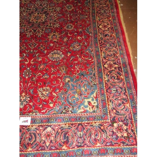 854 - A Northeast Persian Moud carpet with a central motif on red ground, blue spandriels and deep borders... 