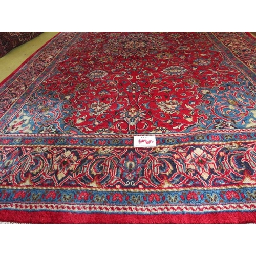 854 - A Northeast Persian Moud carpet with a central motif on red ground, blue spandriels and deep borders... 