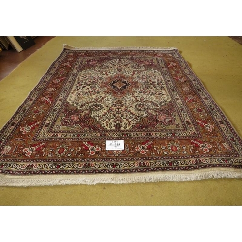 857 - A Northwest Persian Tabriz rug.  Cream, brown and splashes of red.  182cm x 148cm.
Condition report:... 