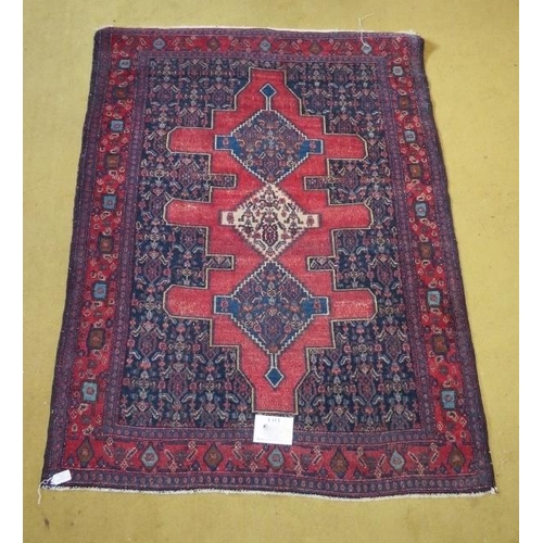 858 - A Persian early 20th Century Tribal Hamadan rug, blue on red ground.  154cm x 117cm.
Condition repor... 