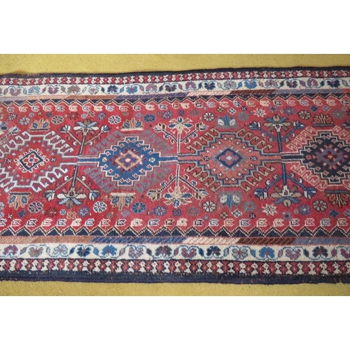 861 - A good early-mid 20th Century Persian runner, ten central linked motifs on red ground. 295cm x 60cm.... 