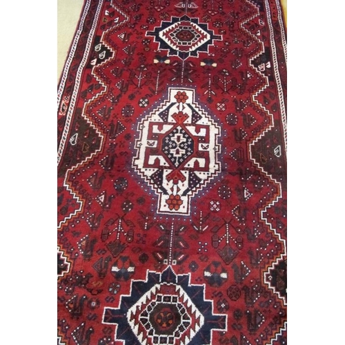 864 - South West Persian Qashqai Runner, three large central motifs on red ground. 275cm x 97cm approx.
Co... 