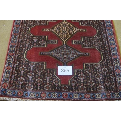 865 - A North West Persian Sennah runner with central repeat motif on red ground.  280cm x 90cm approx.
Co... 