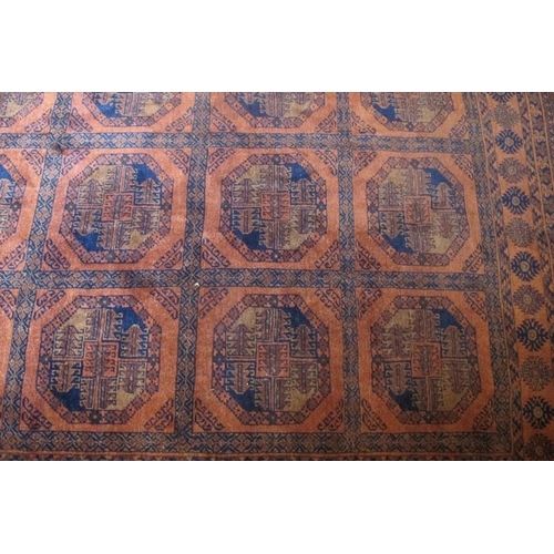 868 - A large early-mid 20th Century Afghan carpet with central block repeat pattern on brown ground. 320c... 