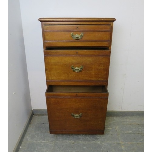 770A - A late Victorian mahogany cabinet of narrow proportions, housing three graduated drawers with presse... 