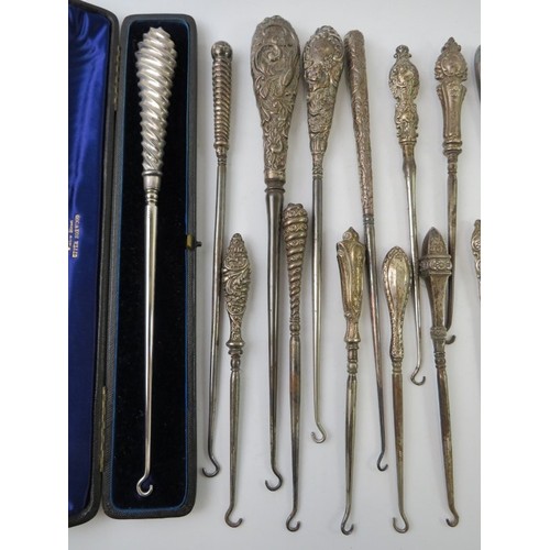 376 - A collection of silver mounted long button hooks of various design including two cased examples. All... 