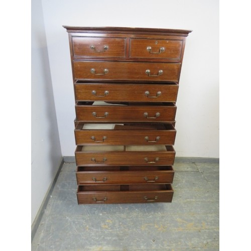 760A - An antique mahogany chest on chest, housing two short and seven long cock-beaded drawers with archit... 