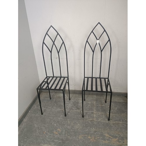 726 - A pair of contemporary artisan-made heavy gauge steel hall chairs, the pierced backs modelled in the... 