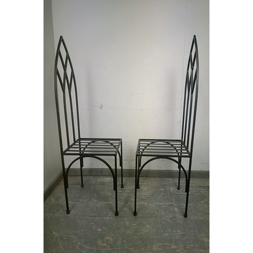 726 - A pair of contemporary artisan-made heavy gauge steel hall chairs, the pierced backs modelled in the... 