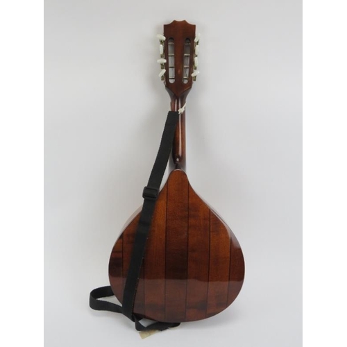 136 - A vintage eight stringed bouzouki by Ozark. Of teardrop form with internal makers label and carry ca... 