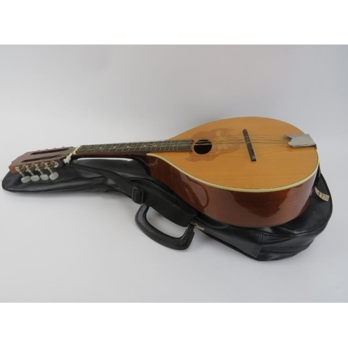 136 - A vintage eight stringed bouzouki by Ozark. Of teardrop form with internal makers label and carry ca... 