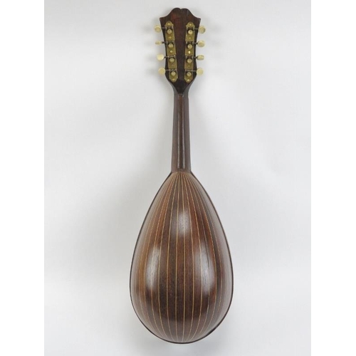 137 - A vintage eight stringed mandolin, 20th century. Parquetry inlaid with a variety of woods throughout... 