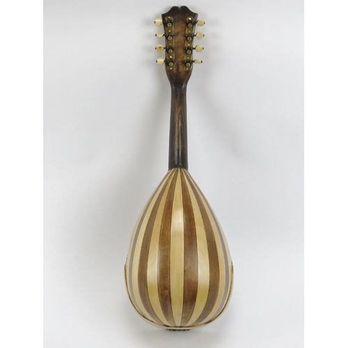 139 - A vintage eight stringed mandolin, 20th century. Inlaid with a variety of woods throughout incorpora... 