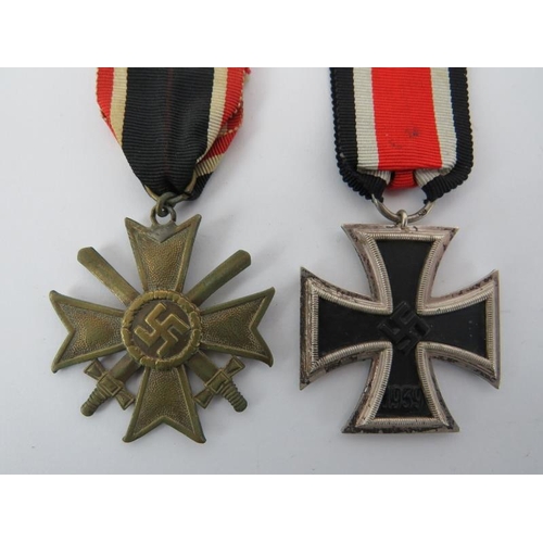 146 - A German WWII Iron Cross and 1939 War Merit Cross with swords. Additional WWII German photographs al... 