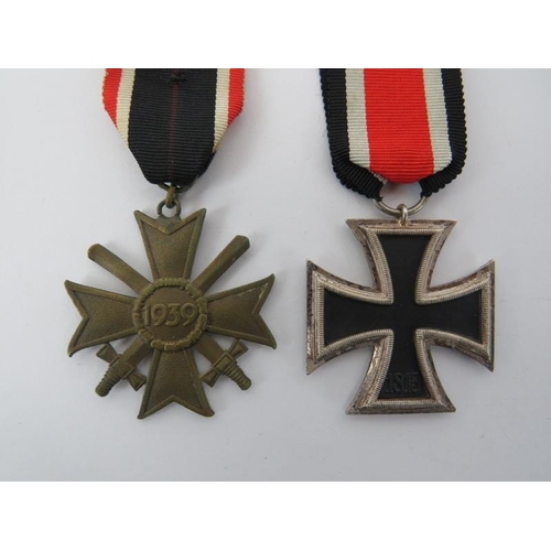 146 - A German WWII Iron Cross and 1939 War Merit Cross with swords. Additional WWII German photographs al... 