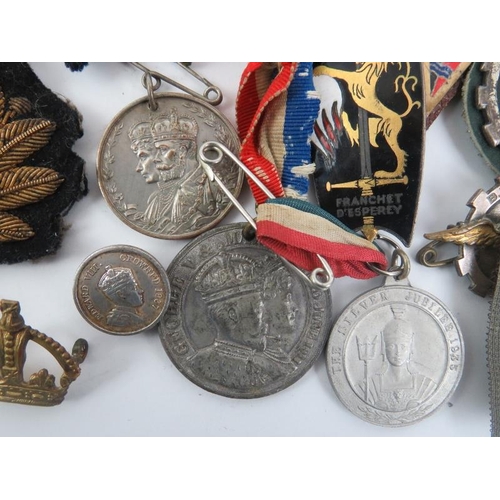 19 - A collection of British military cap badges, George V Jubilee medals, military patches, French ename... 