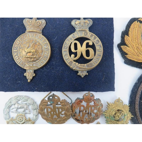 19 - A collection of British military cap badges, George V Jubilee medals, military patches, French ename... 