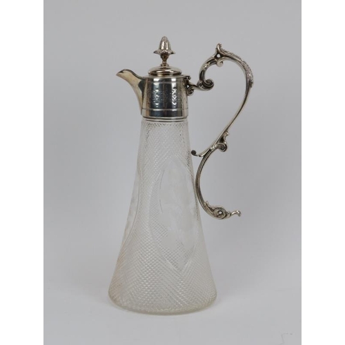 203 - An engraved and silver plate mounted claret jug, late 19th/early 20th century. The elliptical glass ... 