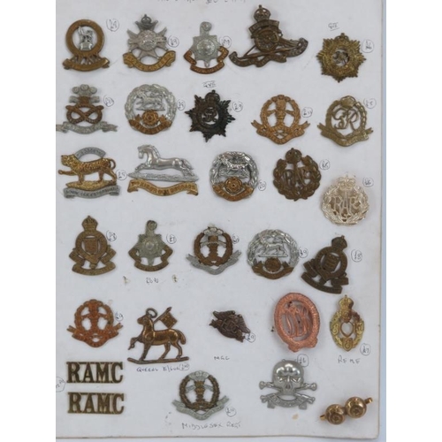 205 - A collection of British military cap badges and related items, early/mid 20th century. (30 items)
Co... 