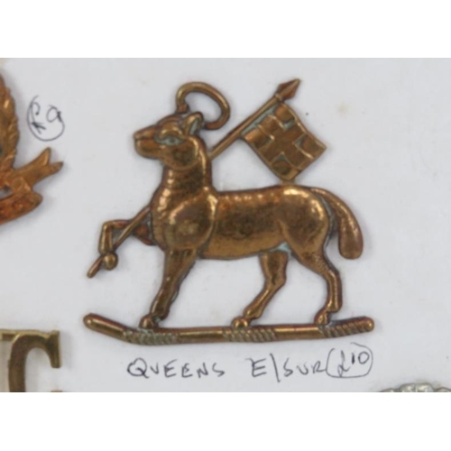 205 - A collection of British military cap badges and related items, early/mid 20th century. (30 items)
Co... 