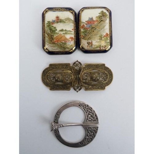 206 - A Japanese satsuma silver backed porcelain belt buckle, a gilt metal belt buckle and a Scottish silv... 