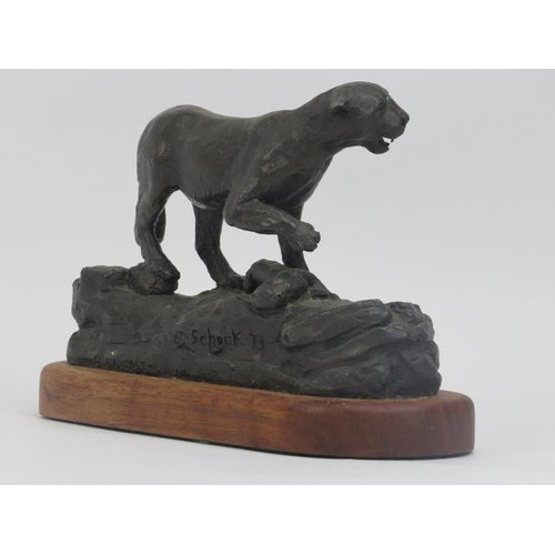 21 - A bronze sculptural figure of a panther, signed and dated. Mounted on a carved oak base. Signed by a... 