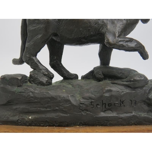 21 - A bronze sculptural figure of a panther, signed and dated. Mounted on a carved oak base. Signed by a... 