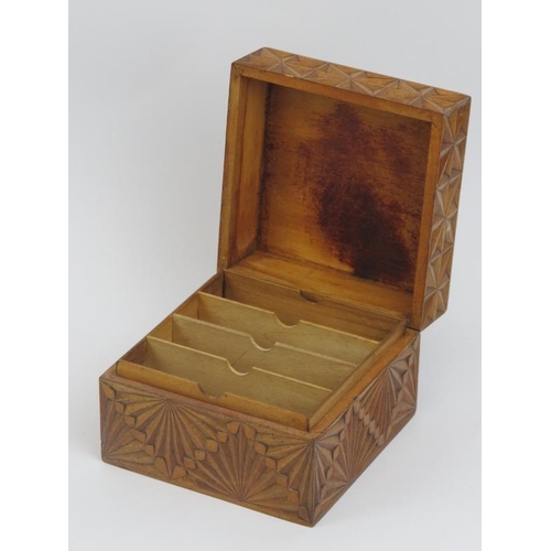 22 - A geometric carved walnut playing card box. With faceted decoration to the hinged cover and sides. 8... 