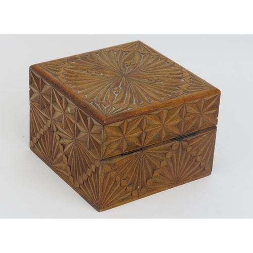 22 - A geometric carved walnut playing card box. With faceted decoration to the hinged cover and sides. 8... 