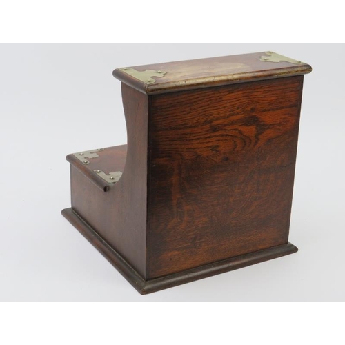 220 - An oak tantalus compartmented for two decanters and a cigarette drawer. 26 cm height, 23.8 cm width,... 