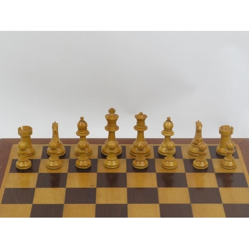 23 - An ebonised wood and sycamore chess set and parquetry inlaid gaming board.
The chess piece bases wei... 