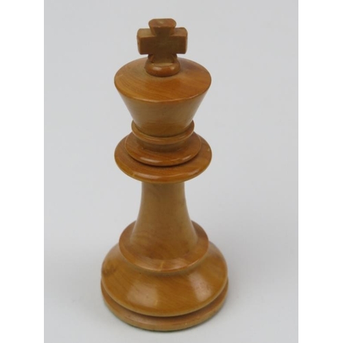 23 - An ebonised wood and sycamore chess set and parquetry inlaid gaming board.
The chess piece bases wei... 