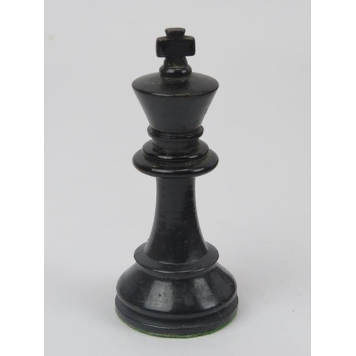 23 - An ebonised wood and sycamore chess set and parquetry inlaid gaming board.
The chess piece bases wei... 