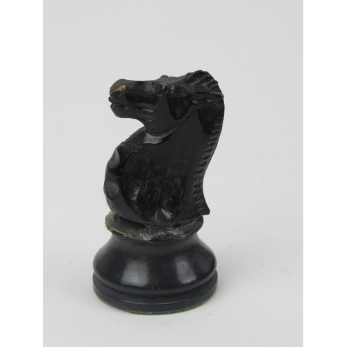 23 - An ebonised wood and sycamore chess set and parquetry inlaid gaming board.
The chess piece bases wei... 