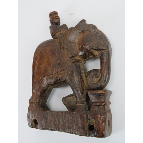 233 - An Indian carved wood figure on an elephant and a Chinese carved and lacquered wood figural carving,... 