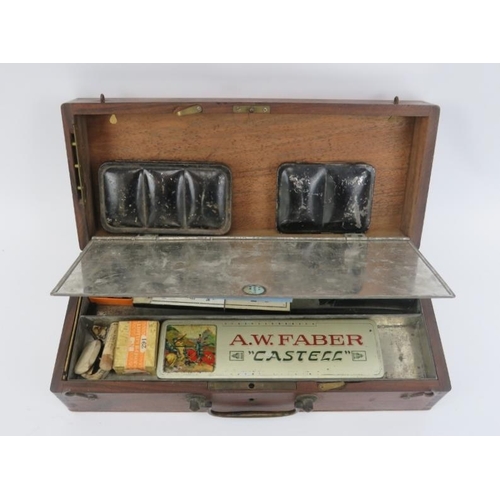 24 - An antique artists travel paintbox, late 19th/early 20th century. With compartmented interior and a ... 