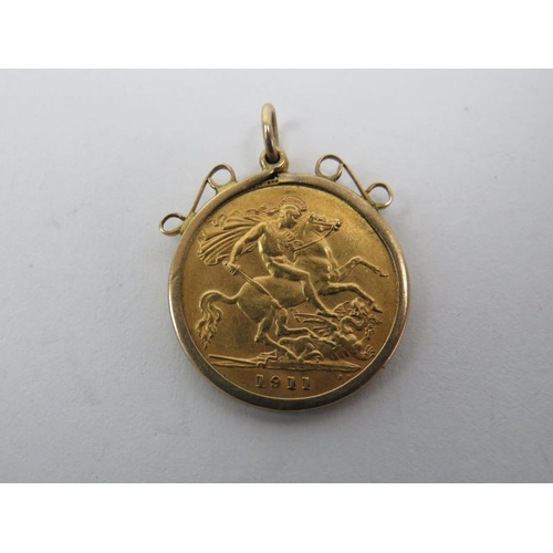 276 - A George V 22ct gold 1911 half sovereign coin enclosed in a 9ct gold pendant fitting. Pendant with s... 