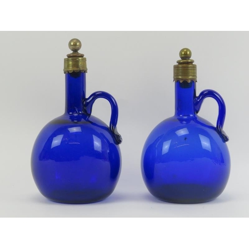 36 - Two Bristol blue glass spirit decanters with stoppers, 19th century. Of flagon form with brass mount... 