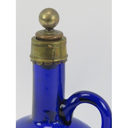 36 - Two Bristol blue glass spirit decanters with stoppers, 19th century. Of flagon form with brass mount... 