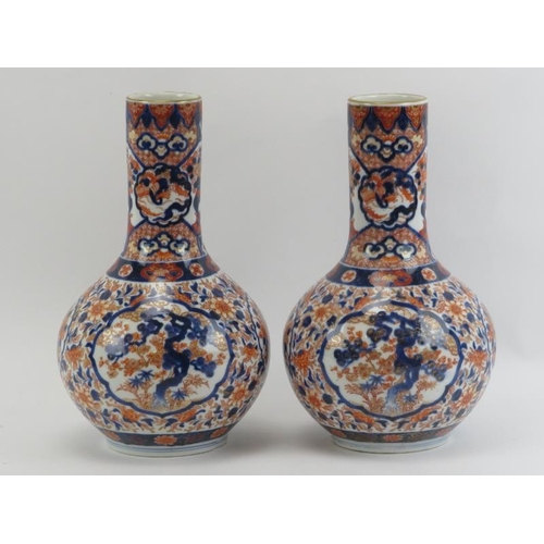 37 - A pair of Japanese Imari porcelain bottle vases, early Meiji period (1868–1912). With ‘Fukagawa sei’... 