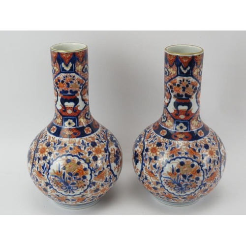 37 - A pair of Japanese Imari porcelain bottle vases, early Meiji period (1868–1912). With ‘Fukagawa sei’... 