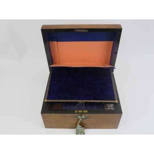 5 - A late Victorian burr walnut travelling vanity box. The gilt tooled leather and velvet compartmented... 