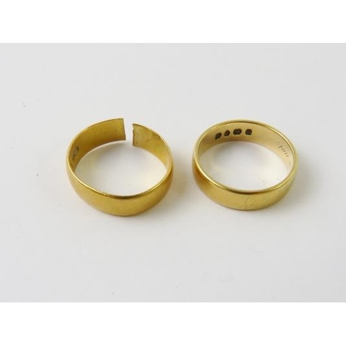 506 - An 18ct yellow gold wedding band; and a 22ct yellow gold wedding band (cut), 10.3gms gross.